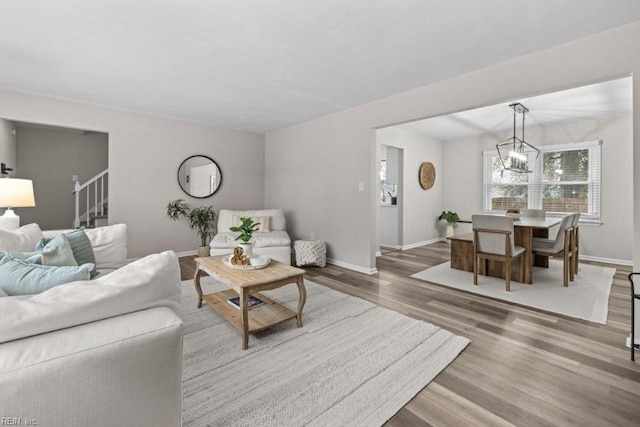 living room with hardwood / wood-style flooring and a chandelier