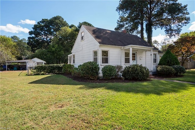 view of property exterior with a carport and a lawn