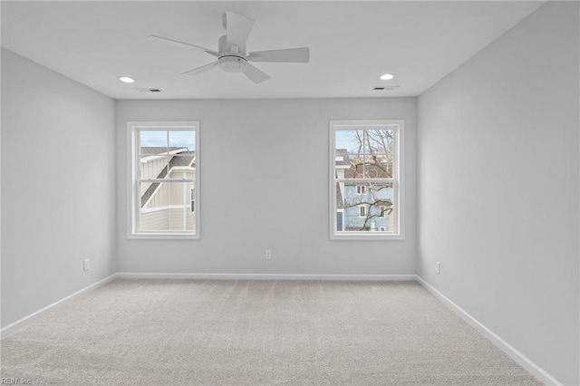 carpeted empty room featuring ceiling fan