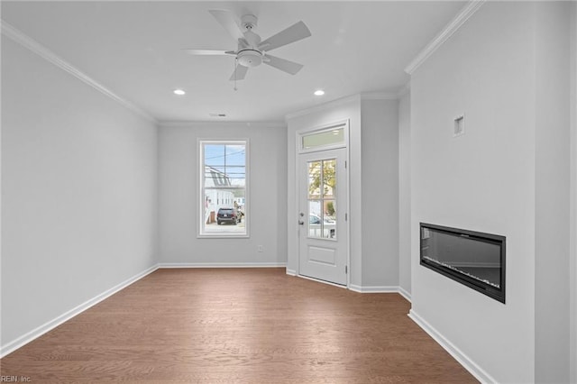 interior space featuring hardwood / wood-style flooring, ornamental molding, and ceiling fan