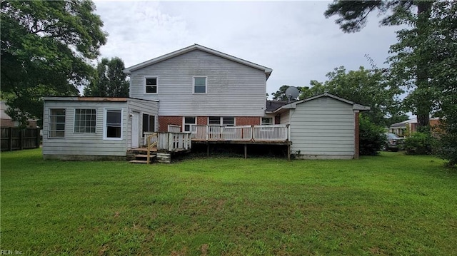 back of house featuring a lawn and a deck