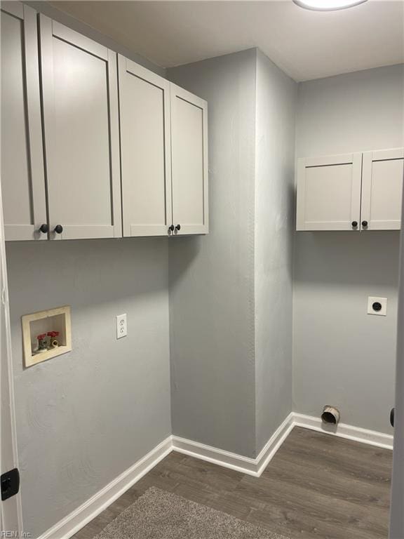 laundry room featuring cabinets, hookup for an electric dryer, dark hardwood / wood-style flooring, and hookup for a washing machine