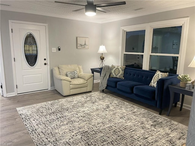 living room featuring ornamental molding, hardwood / wood-style floors, and ceiling fan