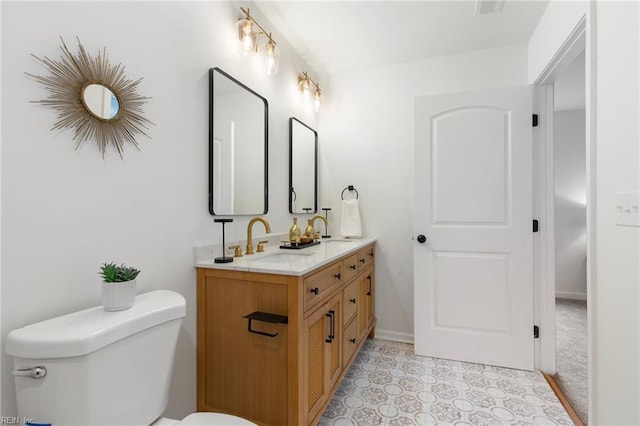 bathroom featuring vanity and toilet