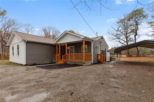 view of front of home with a carport and covered porch