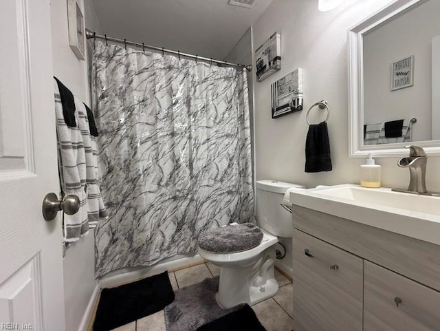 bathroom featuring vanity, a shower with curtain, tile patterned floors, and toilet