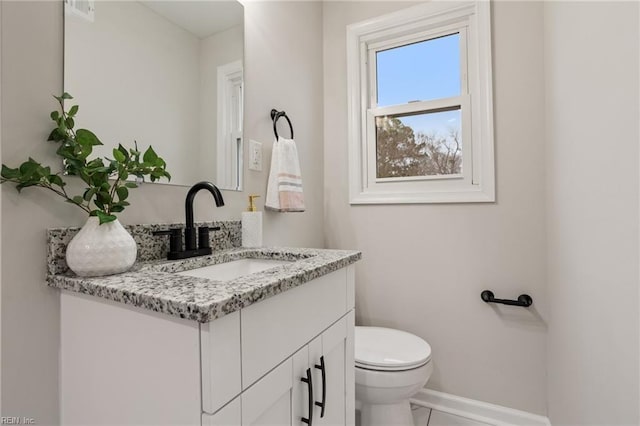 bathroom featuring vanity and toilet