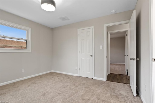 unfurnished bedroom with light colored carpet