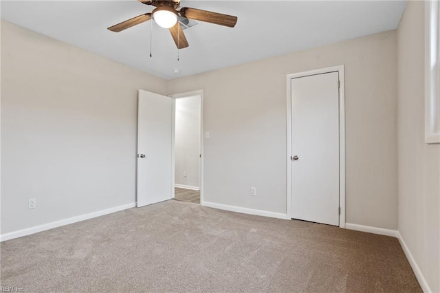 spare room featuring light carpet and ceiling fan