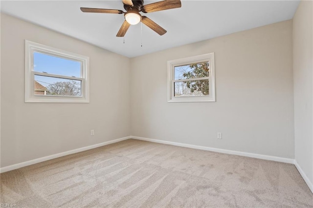 carpeted spare room featuring ceiling fan