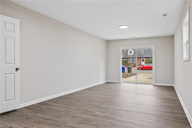 spare room with dark hardwood / wood-style flooring