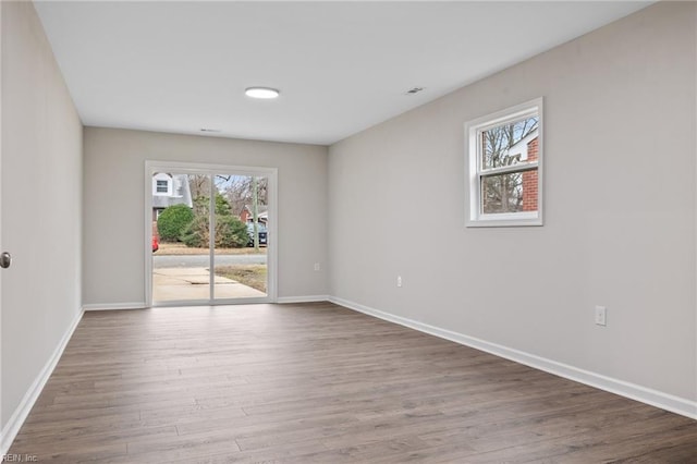 unfurnished room with hardwood / wood-style floors and a wealth of natural light