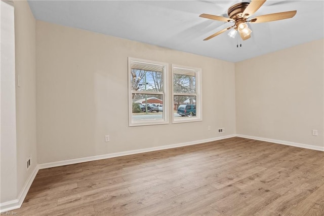 spare room featuring light hardwood / wood-style flooring and ceiling fan