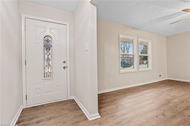 foyer entrance with ceiling fan and light hardwood / wood-style flooring