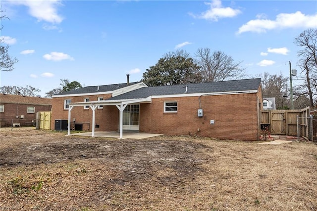 rear view of property featuring central AC and a patio area