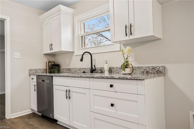 kitchen with sink, dark wood-type flooring, dishwasher, light stone counters, and white cabinets