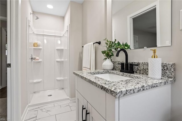 bathroom with a shower and vanity