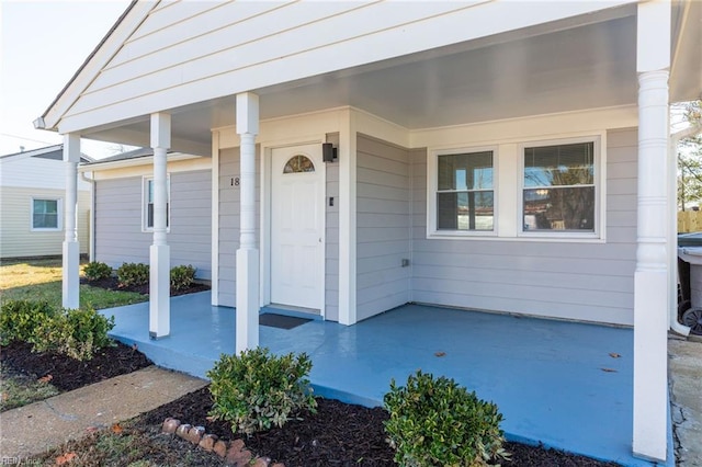 view of exterior entry with covered porch