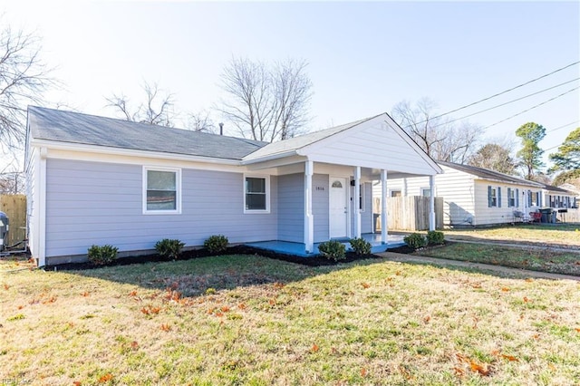 ranch-style home with covered porch and a front lawn