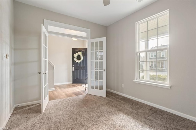 entrance foyer with light carpet and french doors