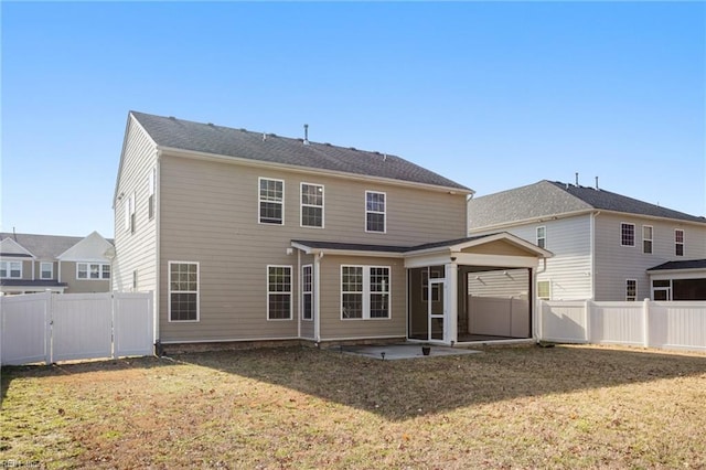 rear view of property featuring a patio area and a lawn