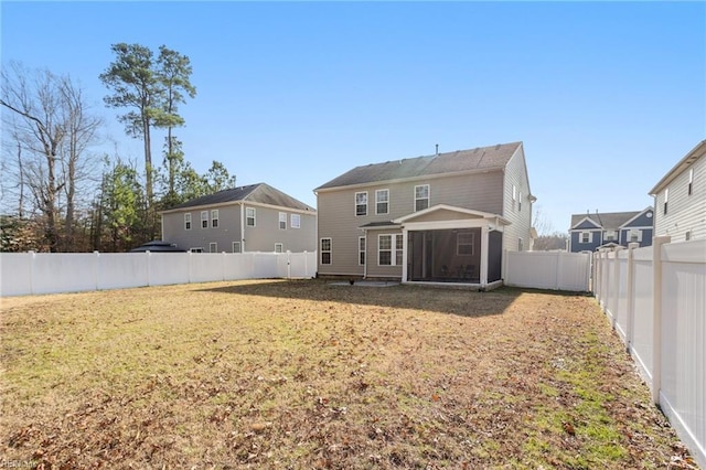 back of house with a lawn and a sunroom