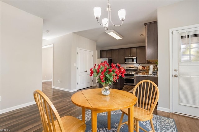 dining area with an inviting chandelier and dark hardwood / wood-style flooring