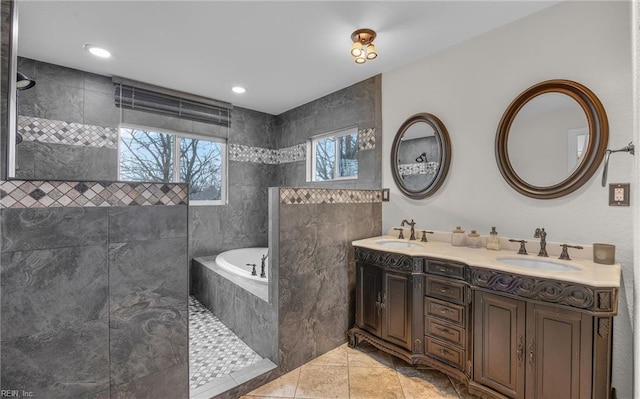 bathroom featuring tile patterned floors, vanity, and shower with separate bathtub