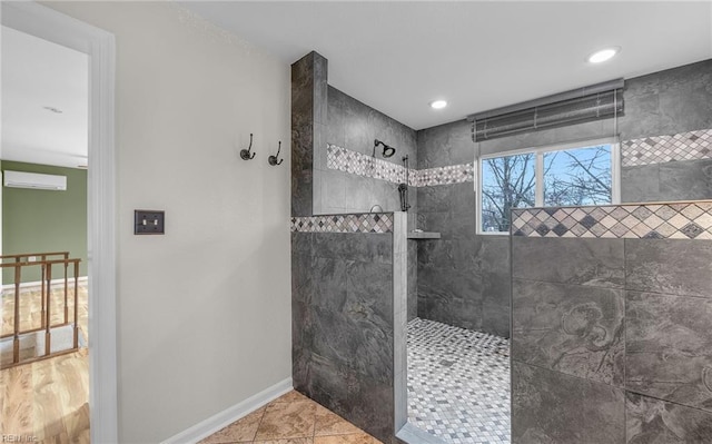 bathroom featuring tile patterned flooring and tiled shower