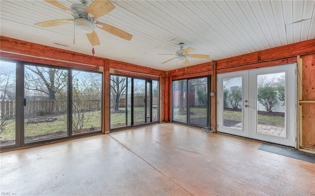 unfurnished sunroom featuring plenty of natural light, french doors, and ceiling fan