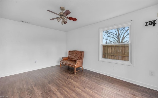 unfurnished room featuring dark wood-type flooring and ceiling fan