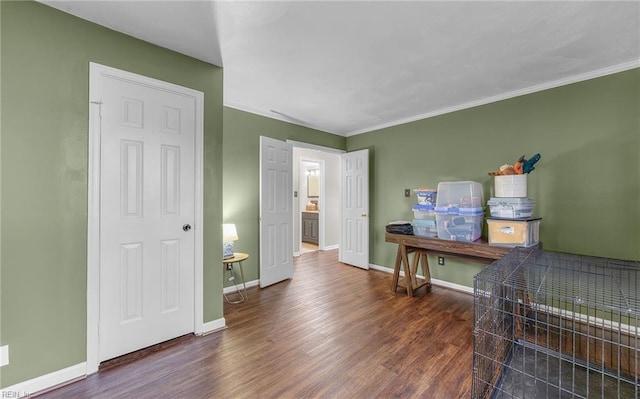 miscellaneous room with ornamental molding and dark hardwood / wood-style floors