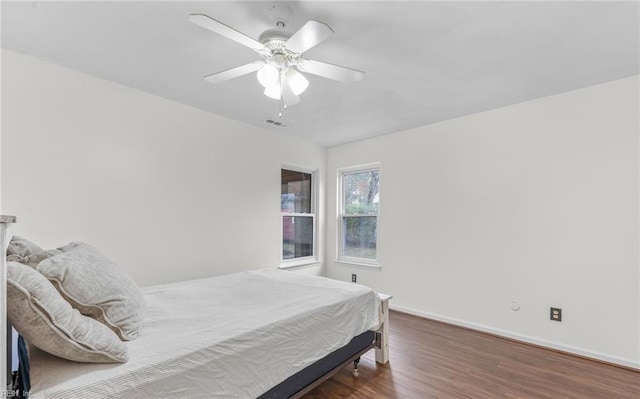 bedroom with ceiling fan and dark hardwood / wood-style flooring