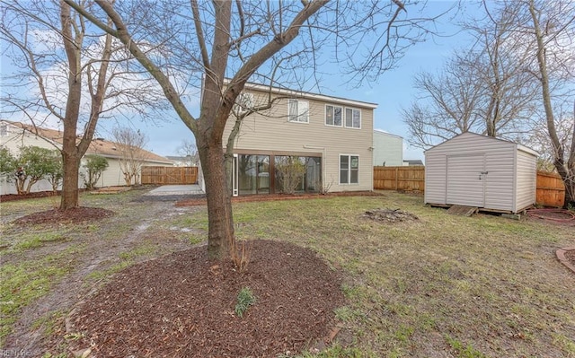 back of house with a yard and a storage shed