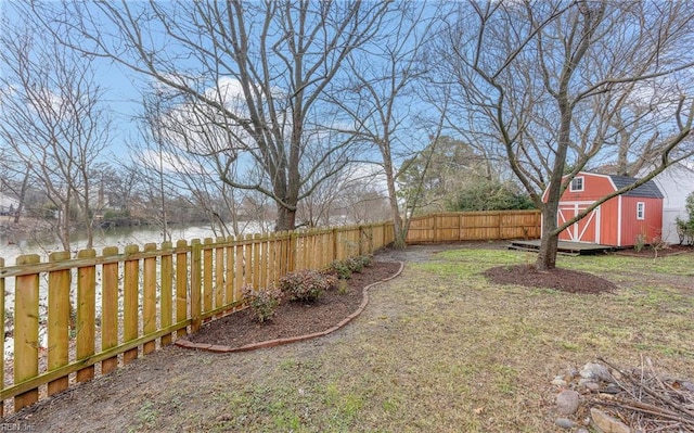 view of yard with a water view and a shed