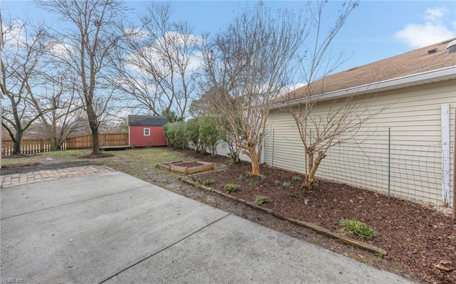 view of yard featuring a patio and a shed