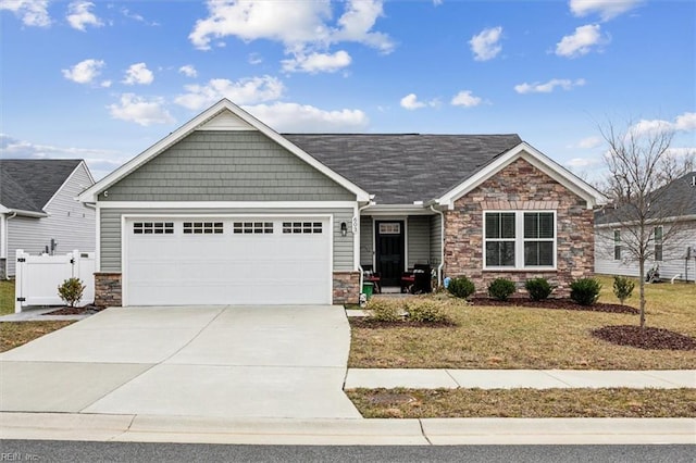 view of front of property featuring a garage and a front yard