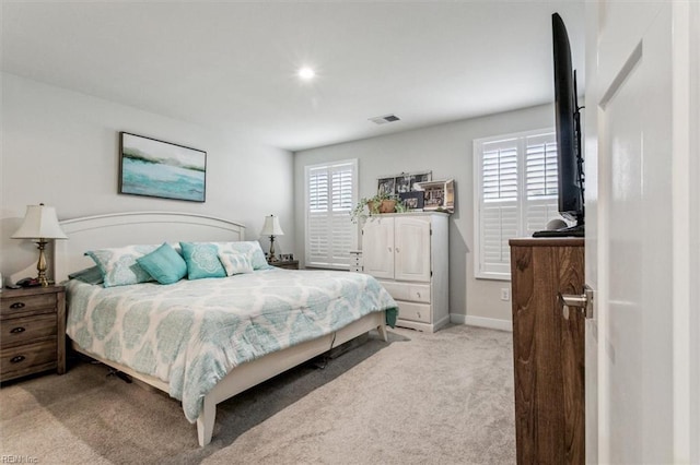 bedroom with light colored carpet