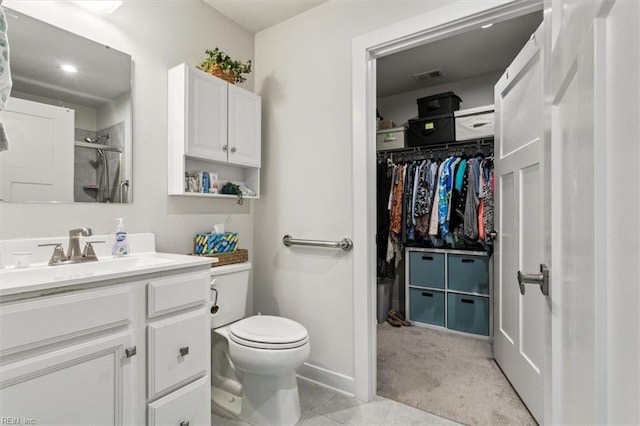 bathroom with vanity, toilet, and a shower with door