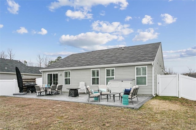 rear view of house with a patio, outdoor lounge area, and a yard