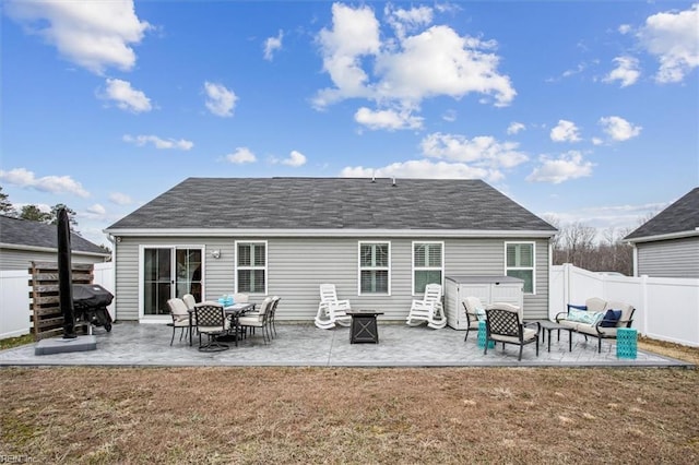 back of house with a lawn, a hot tub, and a patio