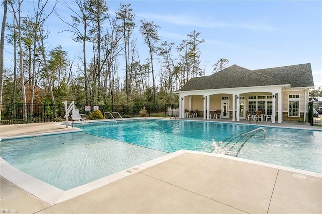 view of swimming pool with a patio and an outdoor structure