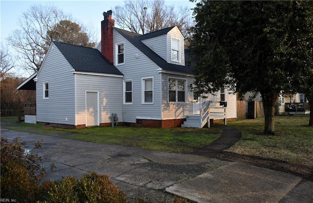 rear view of house with a wooden deck and a yard