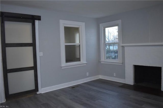 unfurnished living room featuring dark hardwood / wood-style flooring