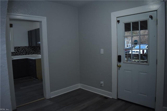 entryway with dark wood-type flooring