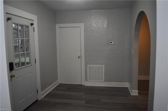 hallway with dark hardwood / wood-style flooring