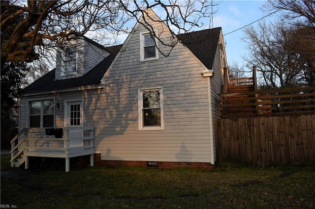 view of side of property featuring a yard and a deck