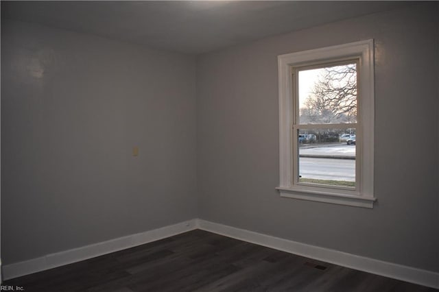 spare room with dark hardwood / wood-style floors