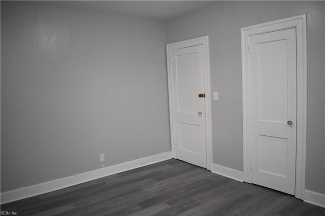 empty room featuring dark hardwood / wood-style flooring