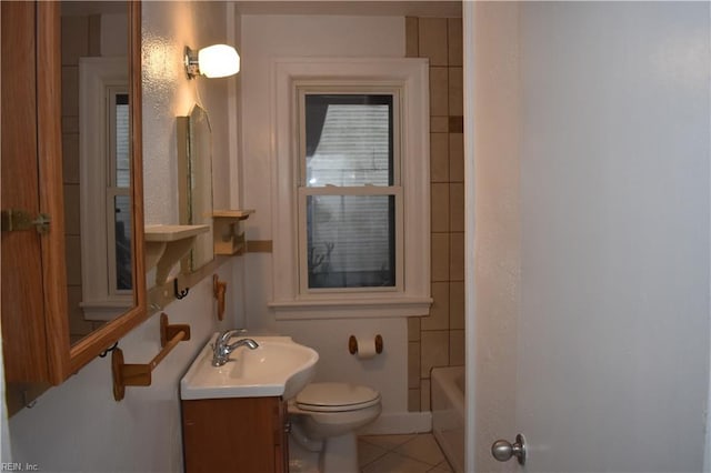 bathroom featuring tile patterned floors, vanity, and toilet